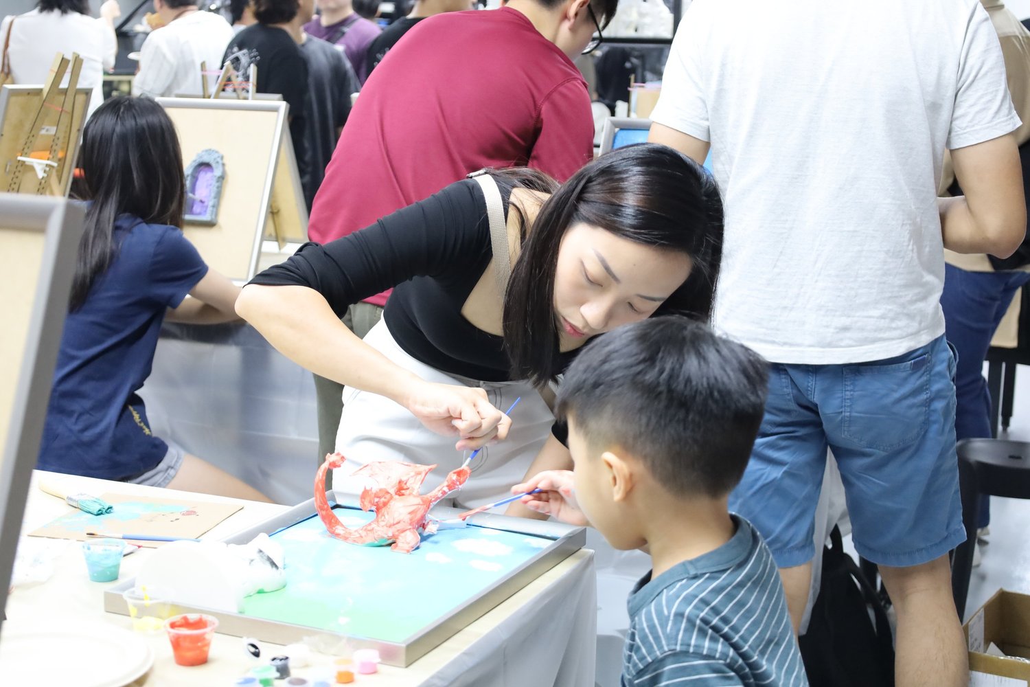 A team at a ColorVerse art-jamming workshop, painting 3D canvases