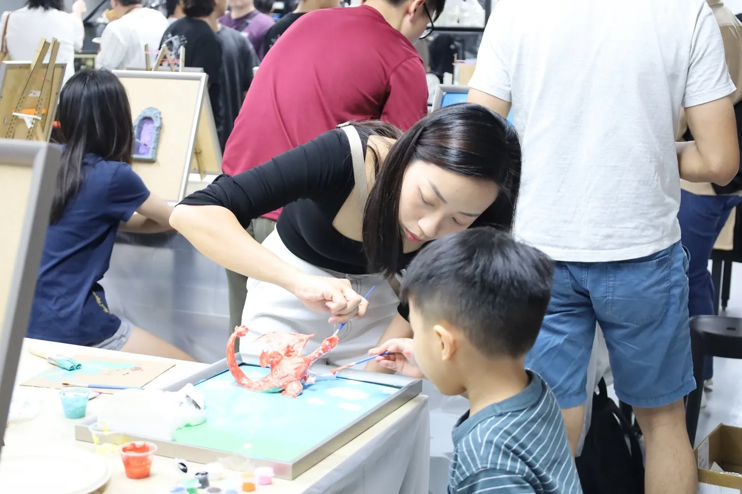 A team at a ColorVerse art-jamming workshop, painting 3D canvases