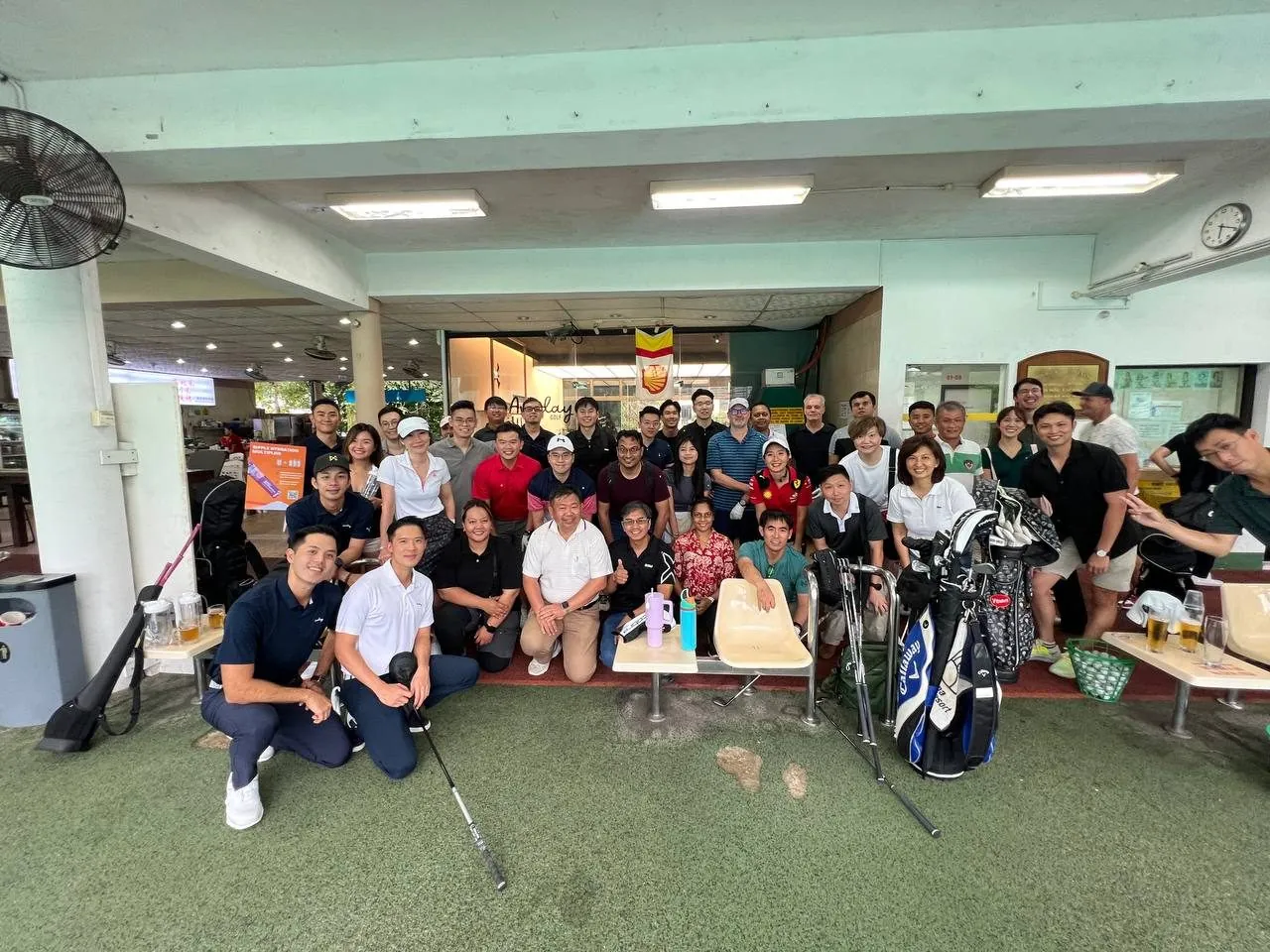 Employees at a corporate golf clinic during a company employee day in Singapore