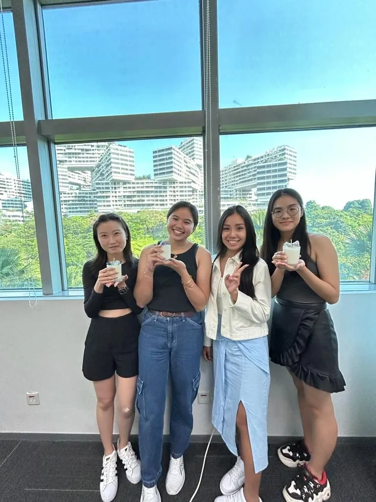 Colleagues making candles together at an indoor team bonding workshop in Singapore