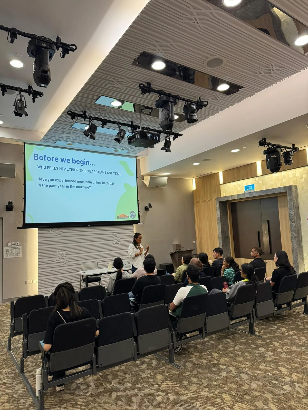 A speaker taking questions at a lunch-hour wellbeing talk for a Singapore office