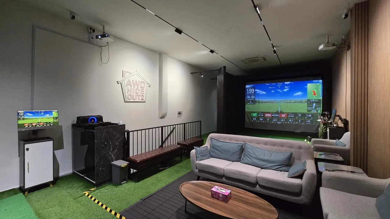 AnyBirdie: two golf simulator bays with lounge seating